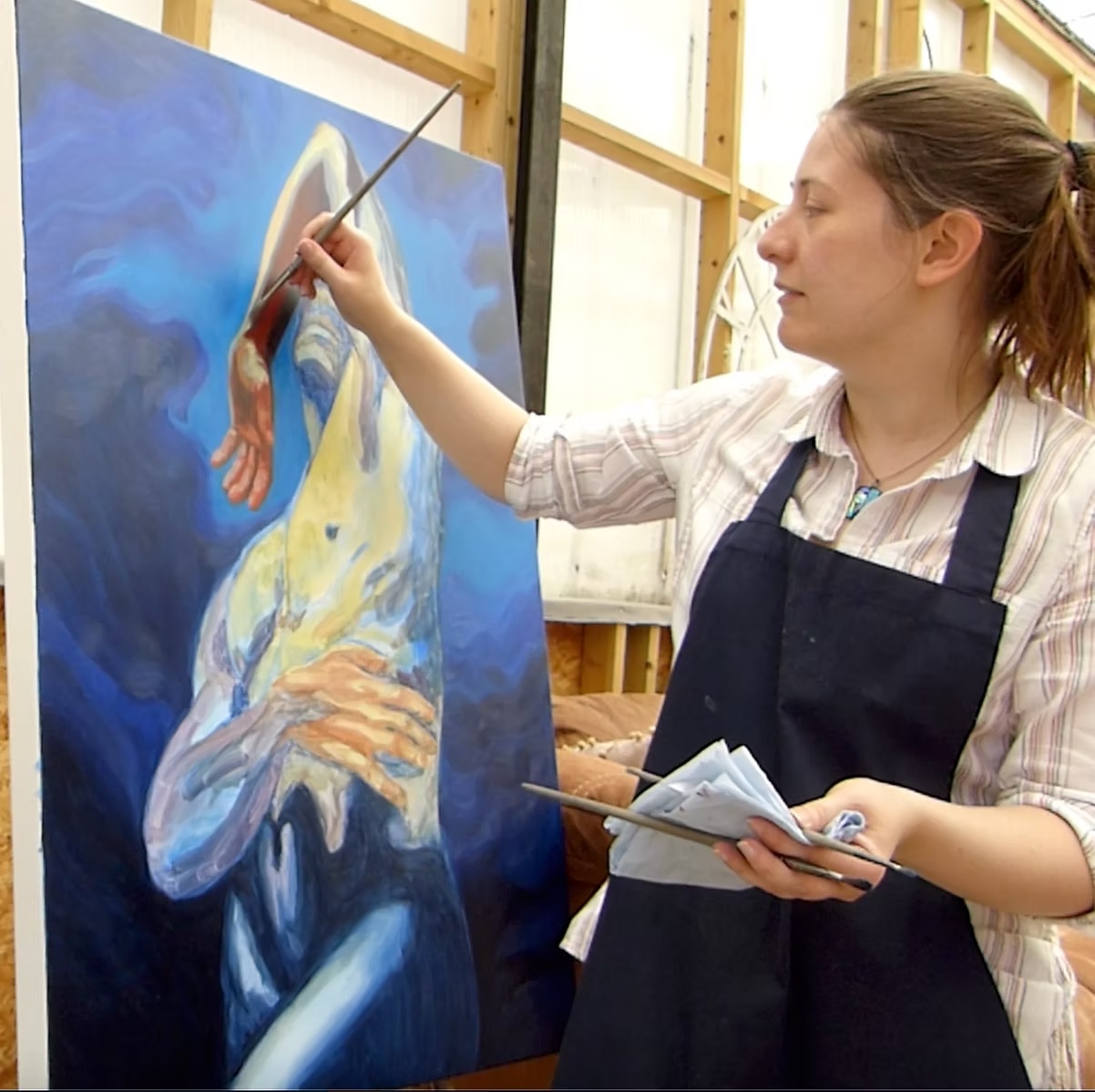 Megan Jeffs painting at an easel
